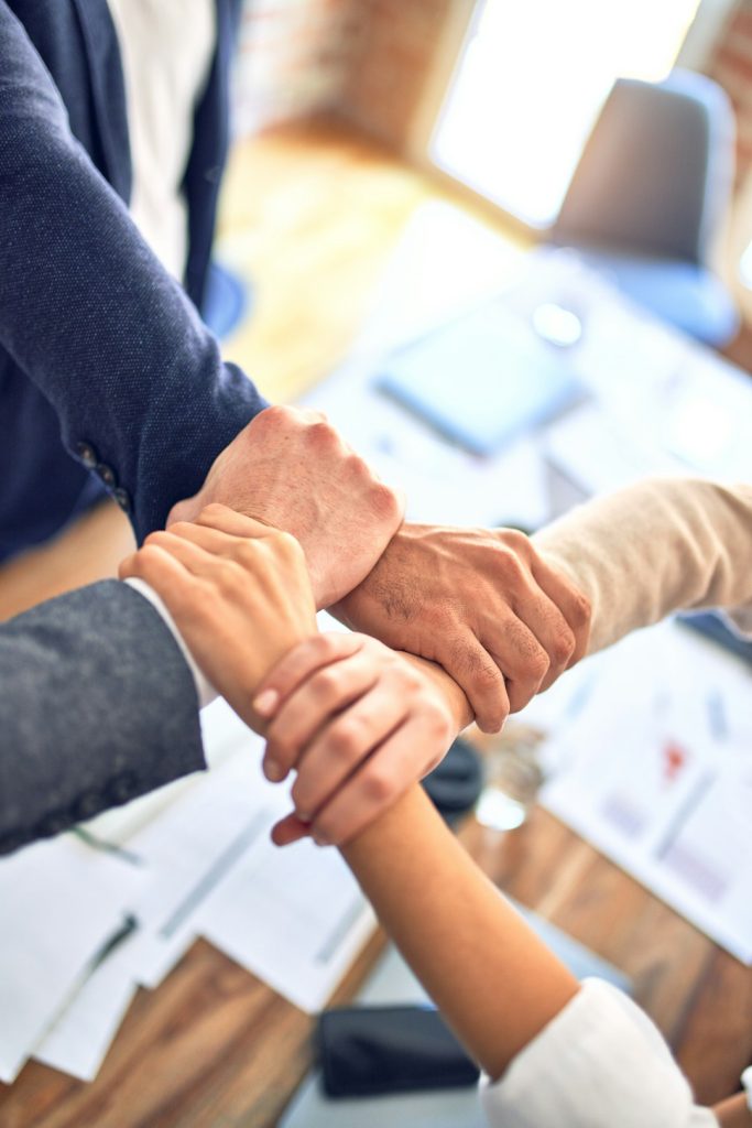 Crafting Captivating Headlines: Your awesome post title goes here Group of business workers standing with hands together doing symbol at the office